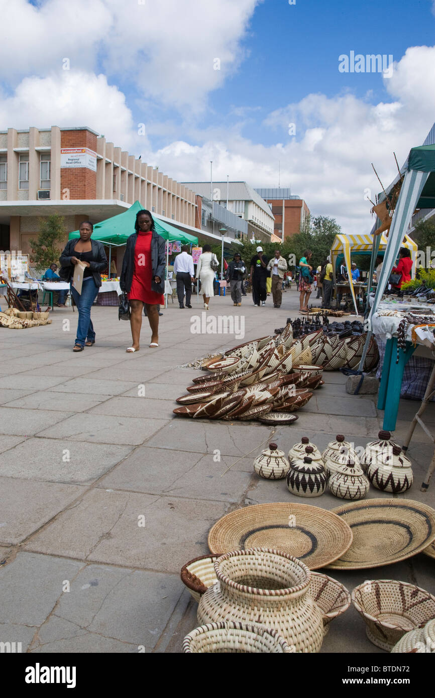 Fußgänger zu Fuß durch den Handwerkermarkt in der alten Main Mall in der Innenstadt von Gaborone Stockfoto