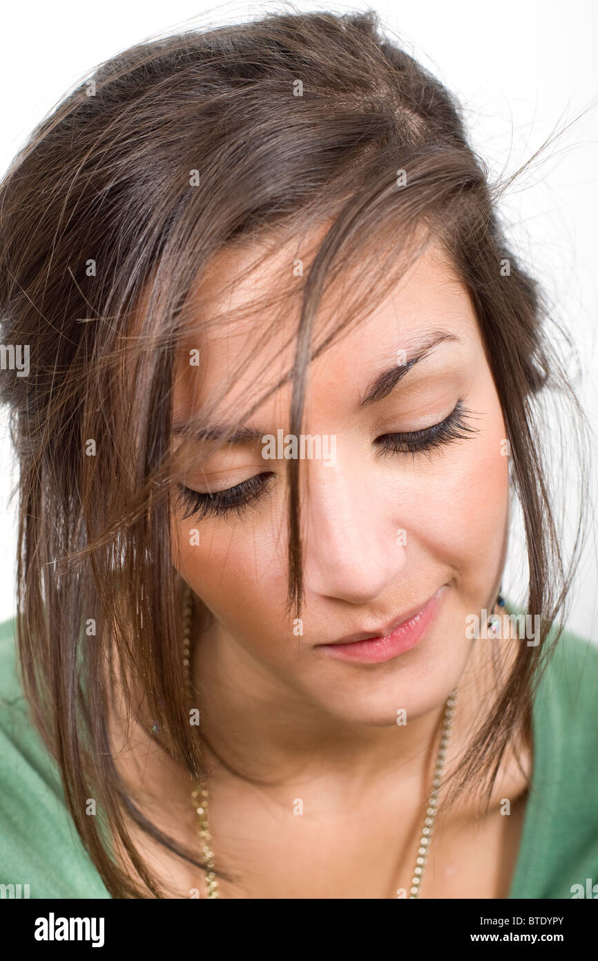 Indoor-Porträt von Teenager-Mädchen auf der Suche nach unten mit Haarausfall über Gesicht Stockfoto
