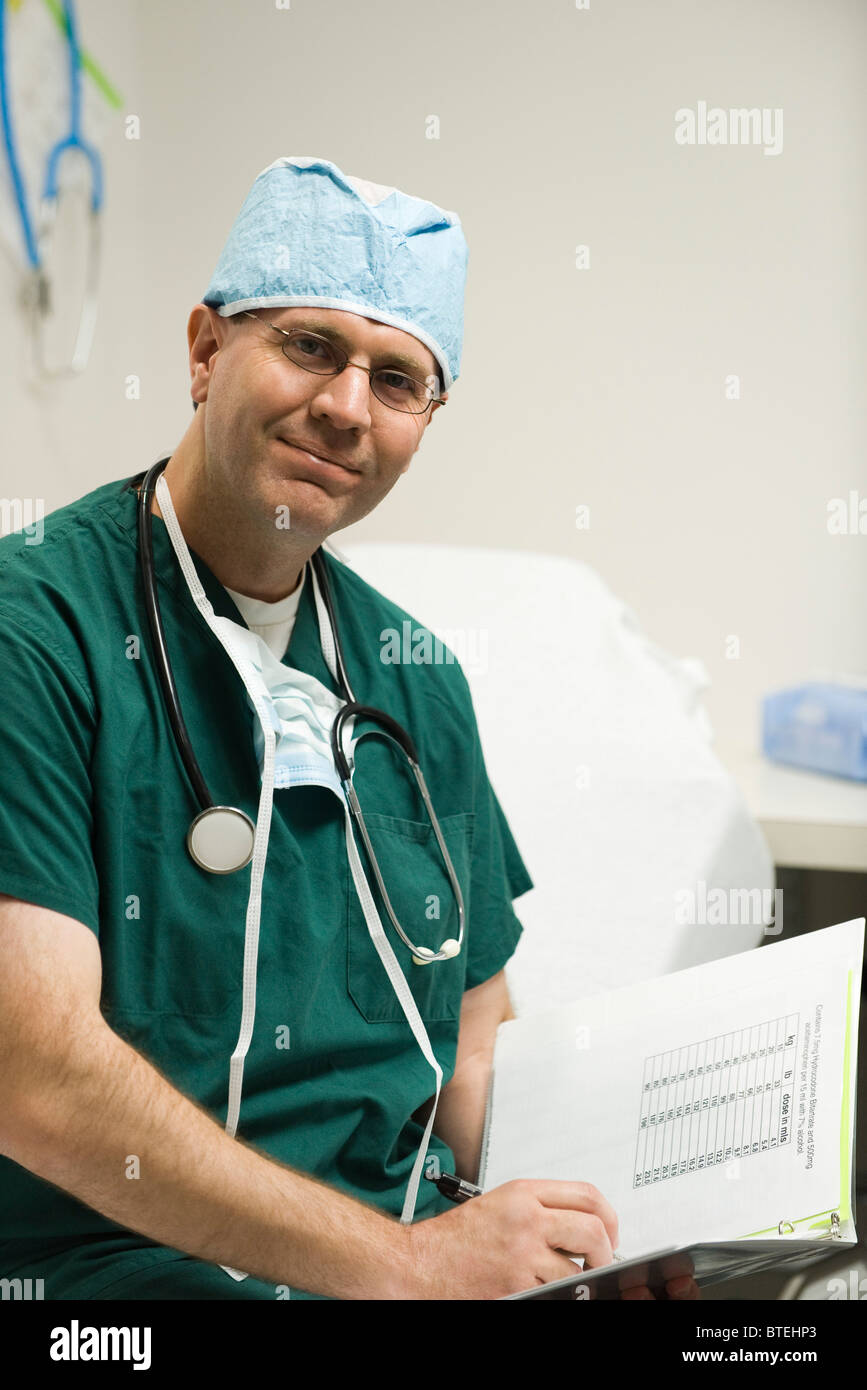 Chirurg Überprüfung medizinische Patientenakte, portrait Stockfoto