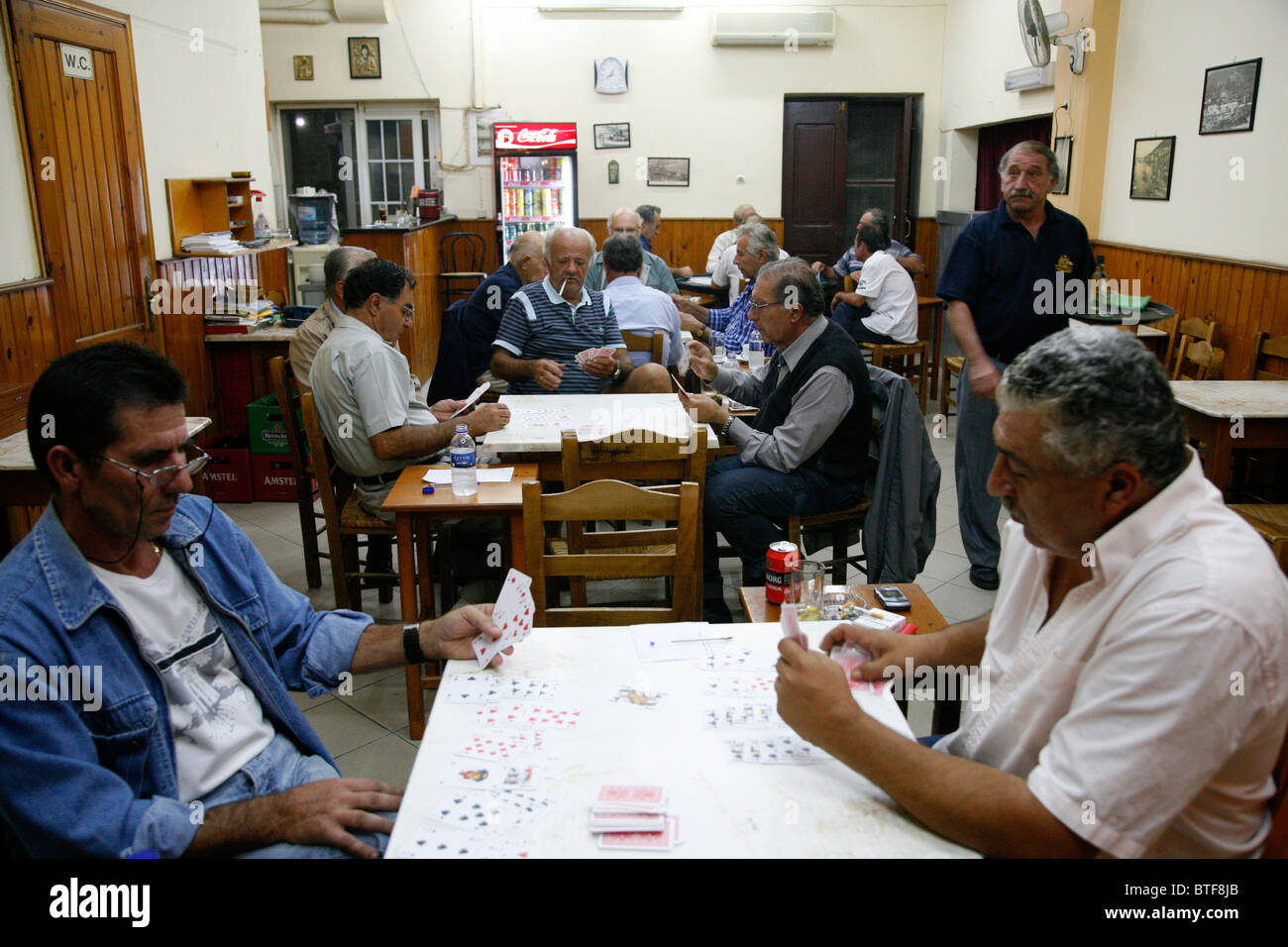 Männer beim Kartenspiel in einem traditionellen Männer Café in Pothia, Kalymnos, Griechenland, Stockfoto