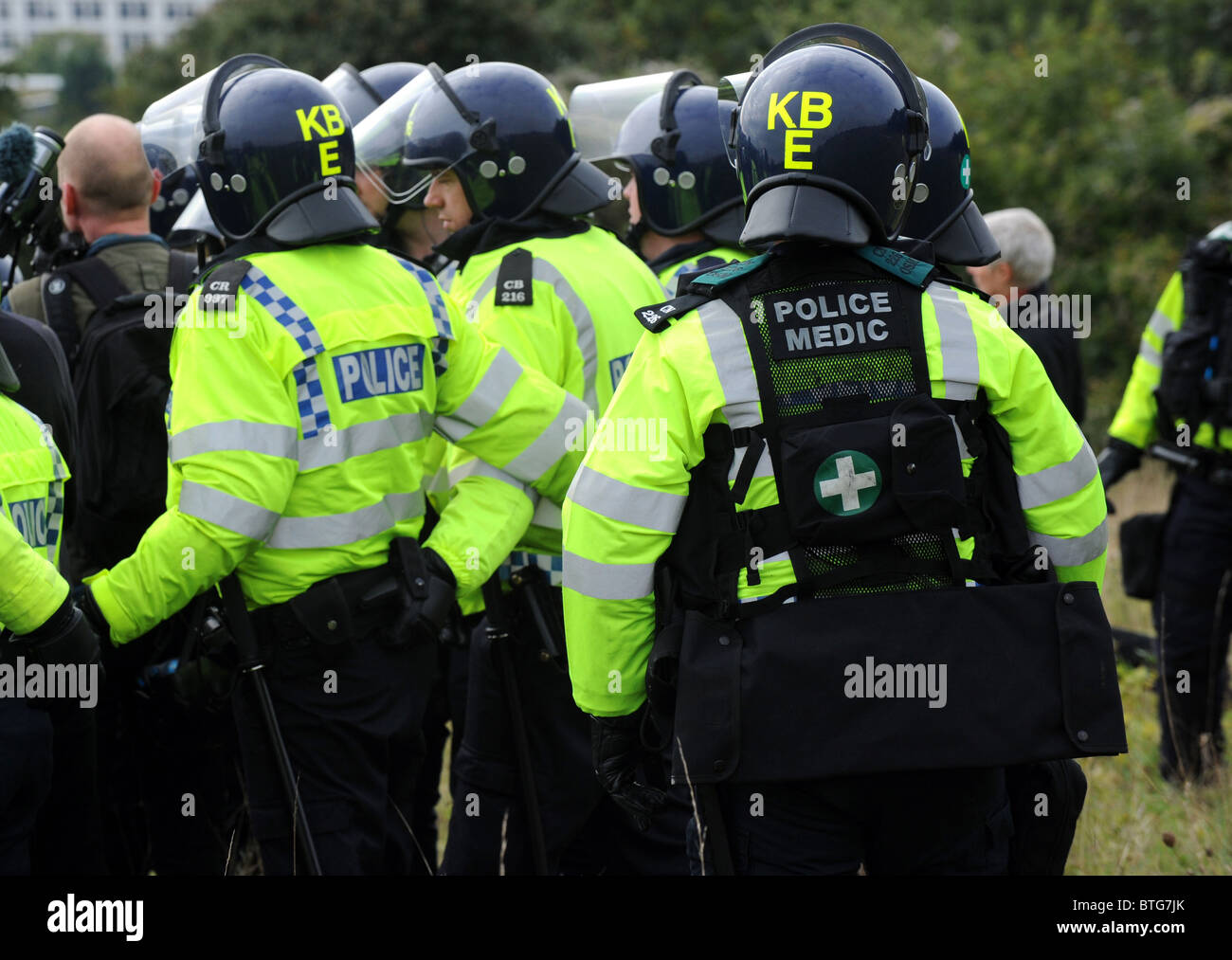Polizisten in Kampfmontur und ein Polizei-Sanitäter befassen sich mit Demonstranten während eines aktuellen Smash EDO in Brighton statt Stockfoto