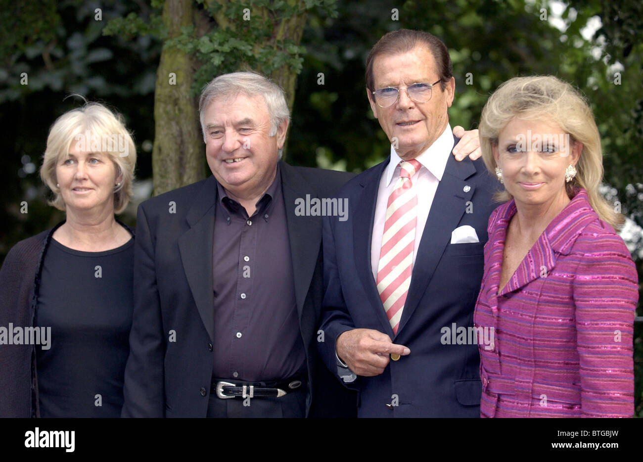 KOMIKER JIMMY TARBUCK UND FRAU SCHAUSPIELER ROGER MOORE UND KIKI THORSTRUP BEI DAVID FROST PARTY IN CHELSEA, LONDON Stockfoto