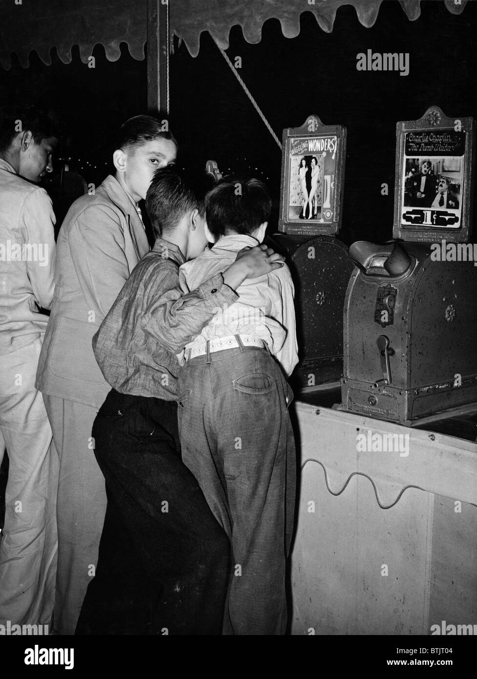 Jungen mit Blick auf Penny Filme an South Louisiana State Fair, wackeln Wunder, neben einer Maschine zeigt Charlie Chaplin anzeigen Stockfoto