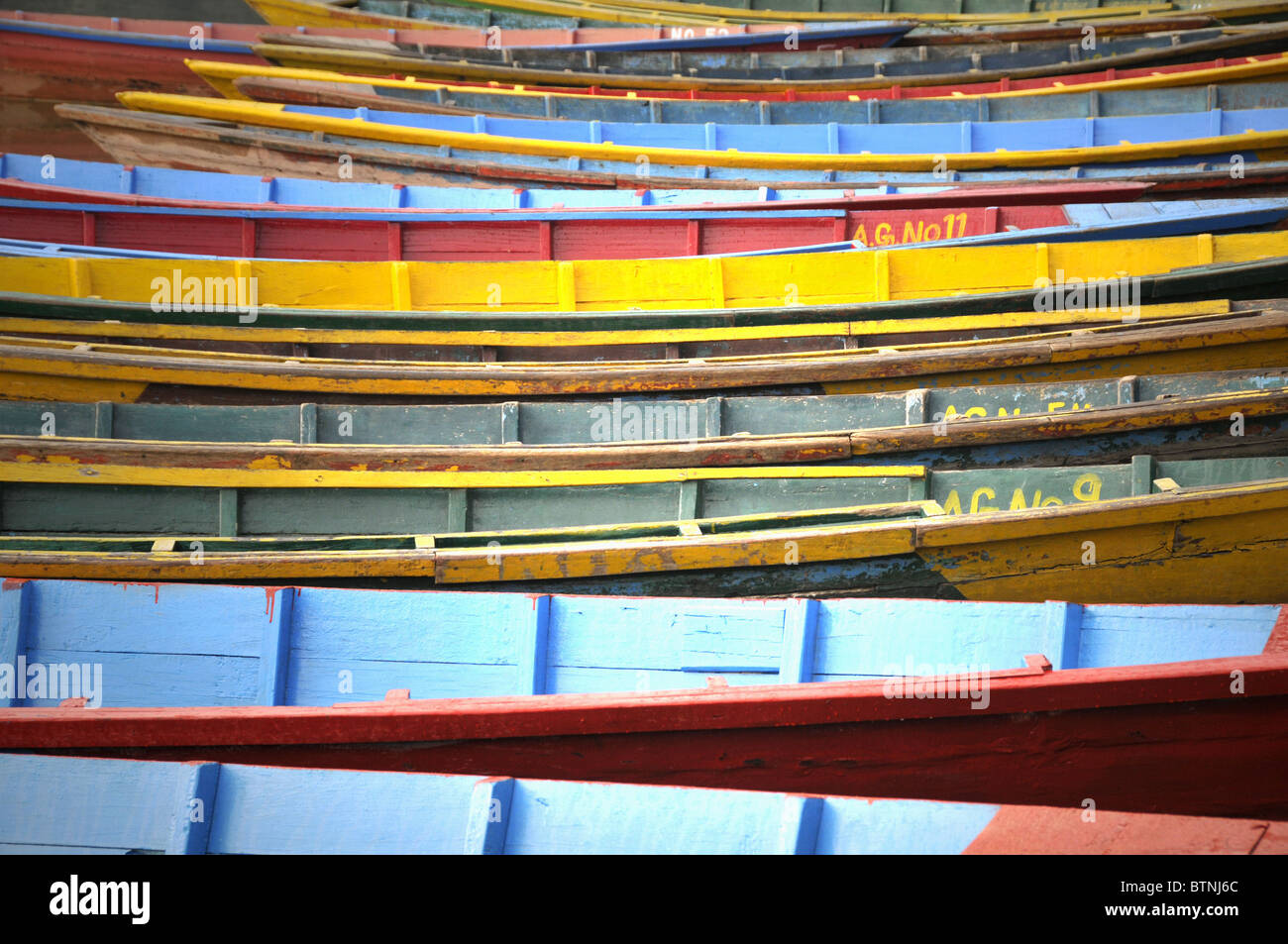 Reihe von farbigen Holzboote am Rande des Flusses Seti Gandaki, Pokhara, Nepal. Stockfoto