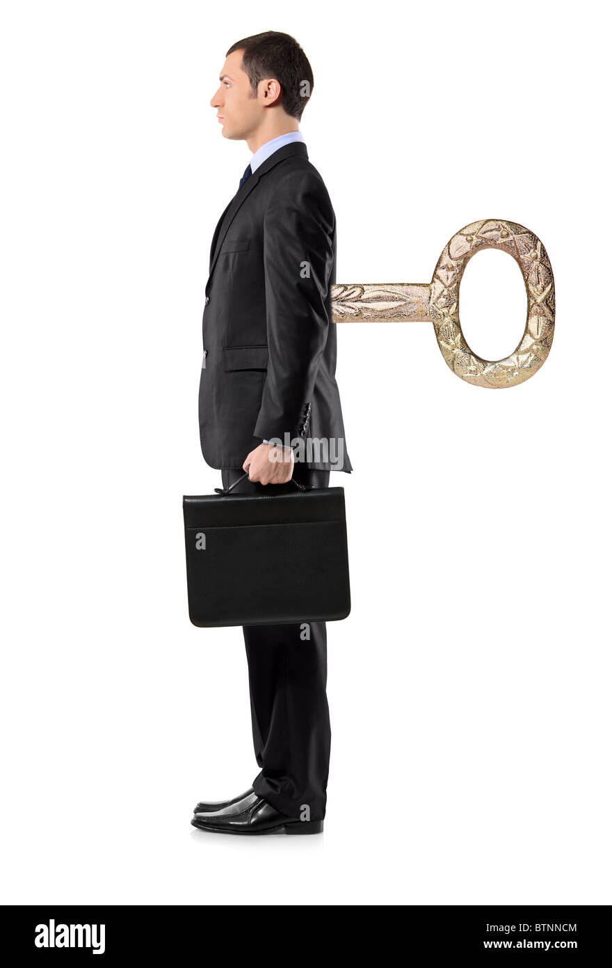 In voller Länge Portrait eines Geschäftsmannes mit Aufzieh-Schlüssel in seinem Rücken Stockfoto