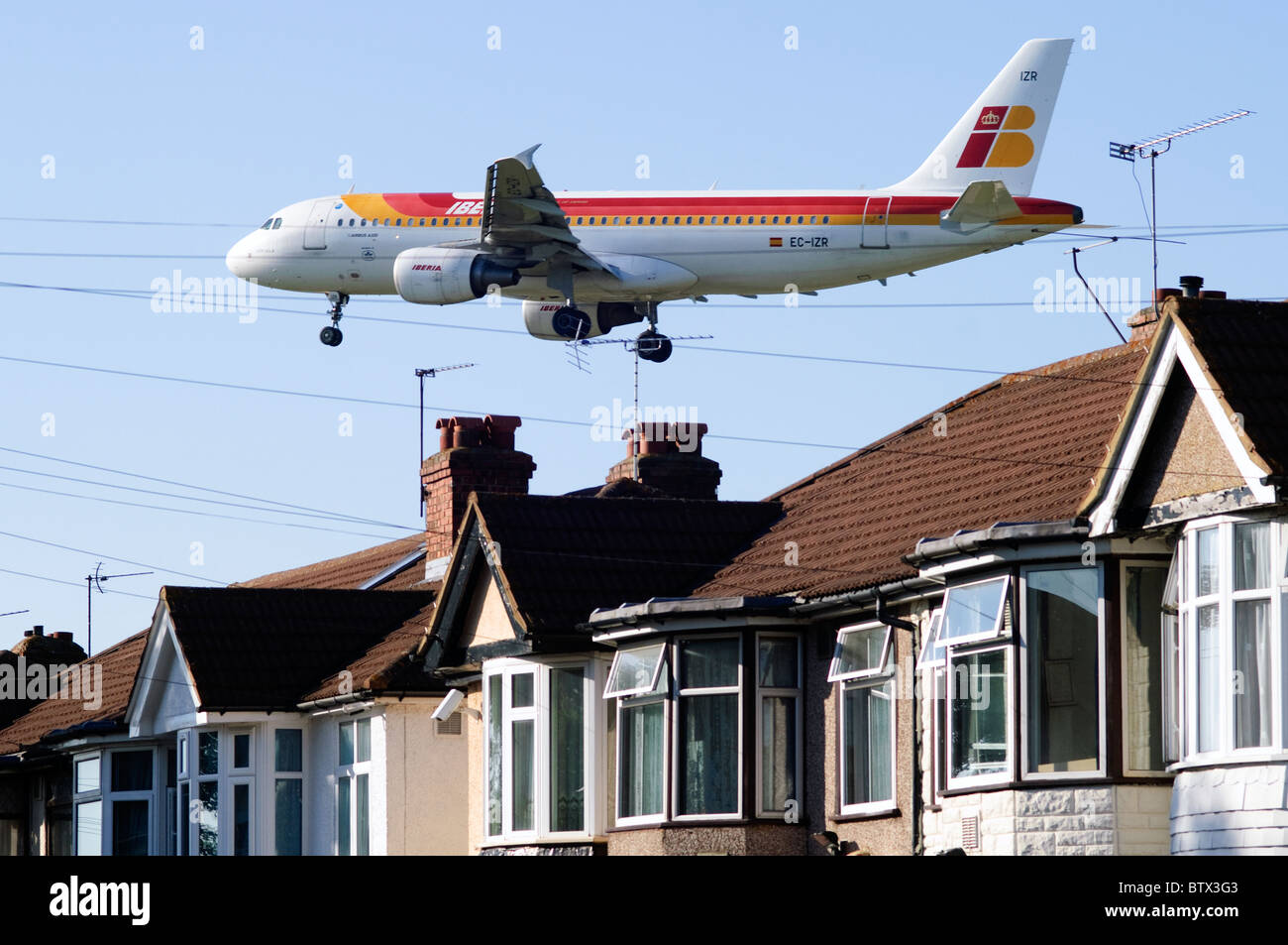 Iberia Airbus A320 nähert sich Heathrow runway niedrig über Bedfont Häuser und Dächer, London Heathrow Flughafen, Großbritannien. Stockfoto