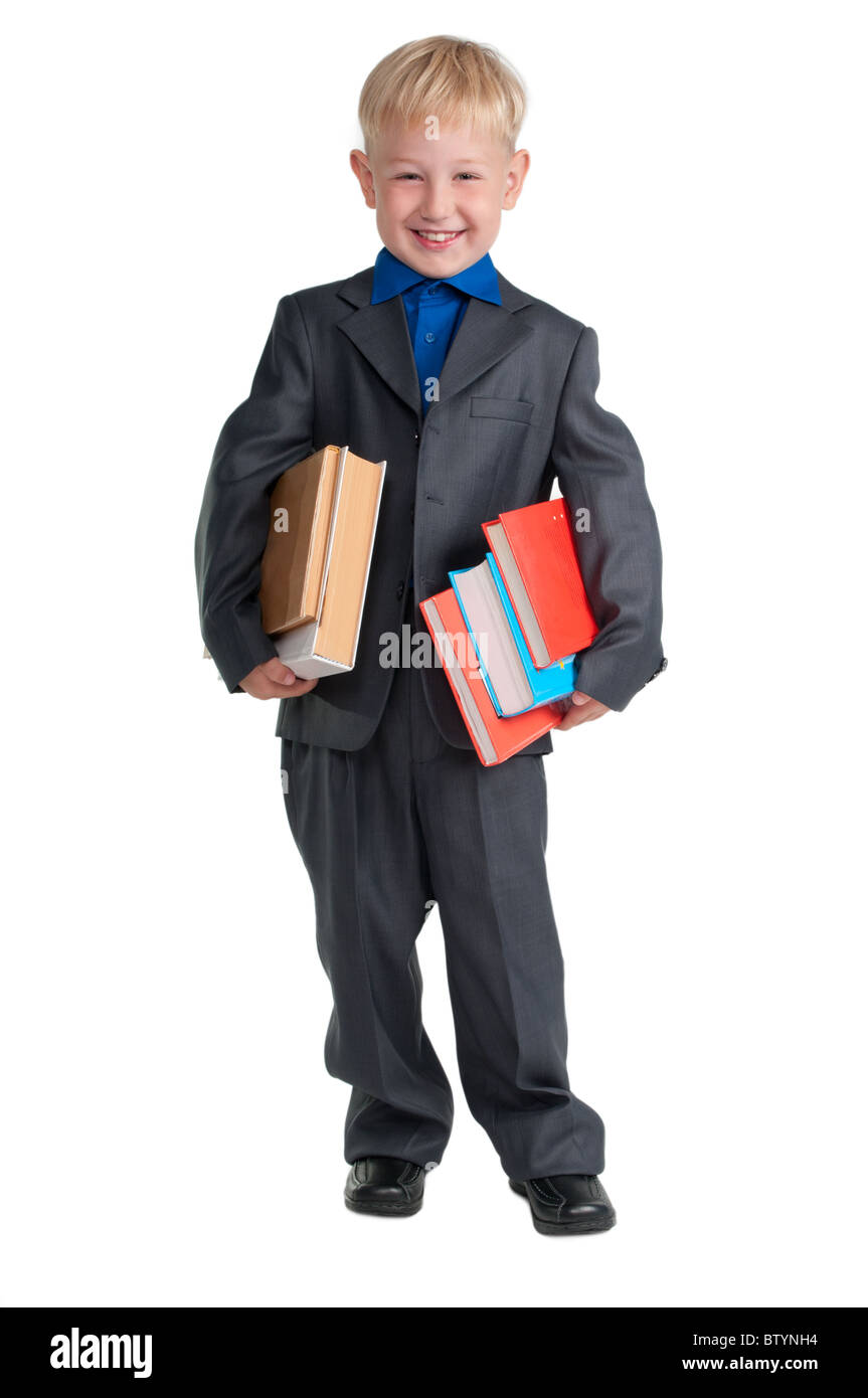 Junge Schüler mit schweren Büchern unter seinen Armen Stockfoto