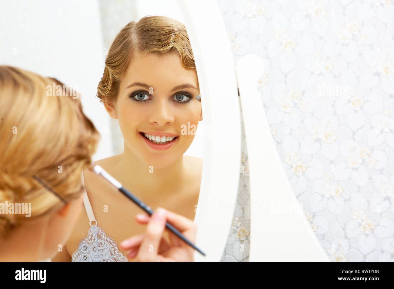 Bild der hübschen weiblichen Blick in Spiegel und Make-up zu tun Stockfoto