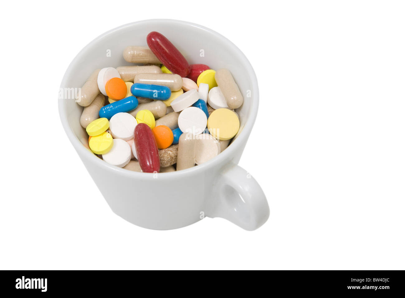 Vorderansicht von Tasse bunte Tabletten und Kapseln Stockfoto