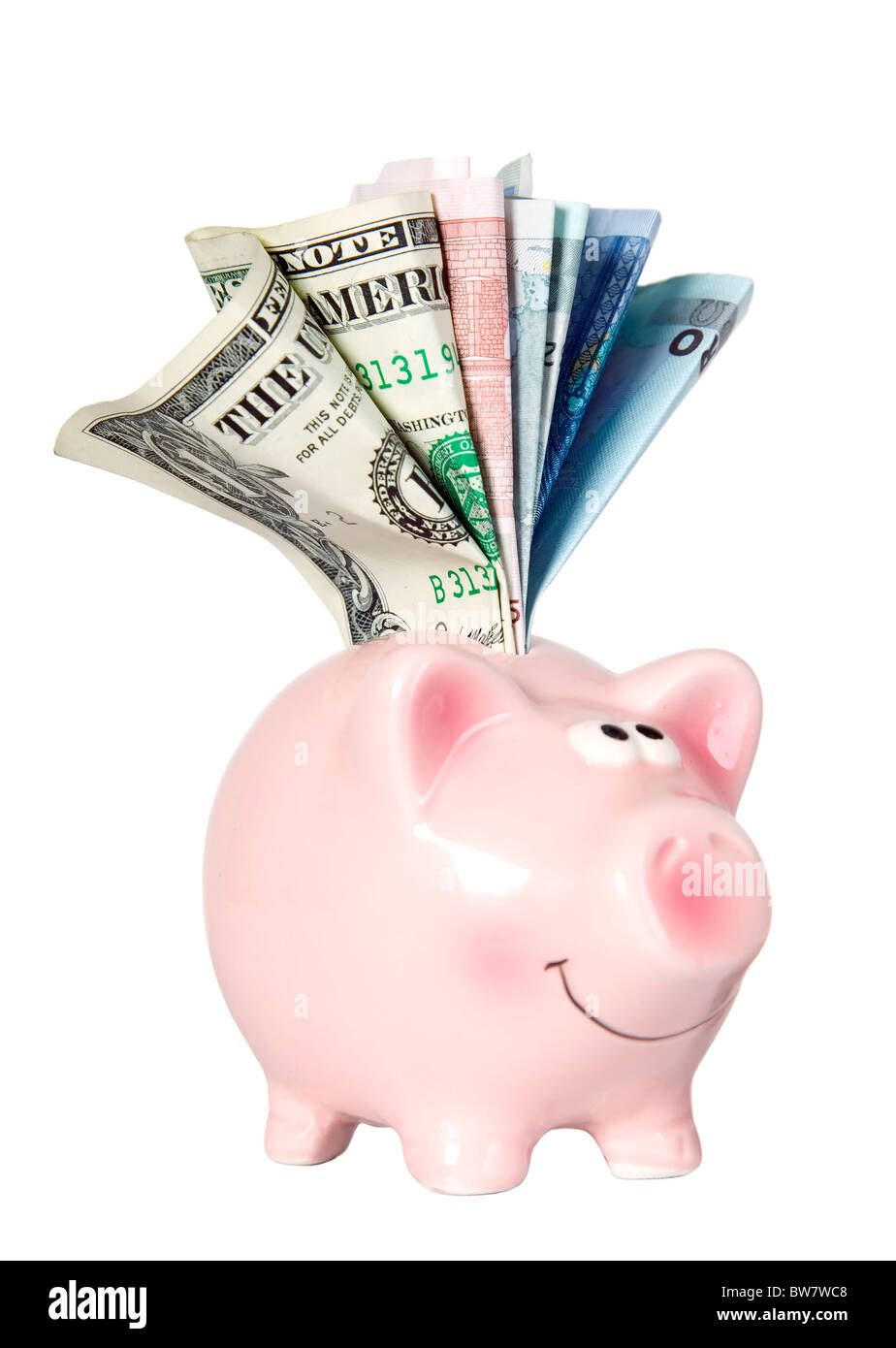 Lächelt und stehend mit Geld sparen Schwein Stockfoto