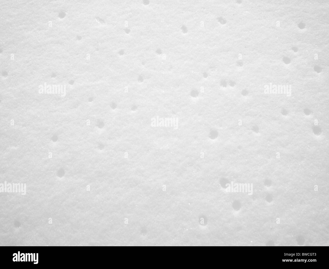Schnee-Textur mit Löchern in den gefrorenen Schnee Stockfoto