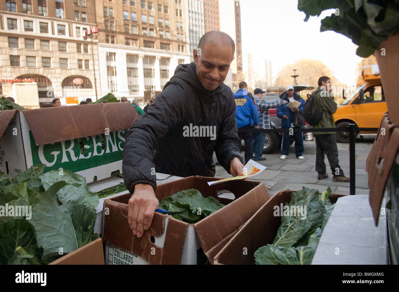 Freiwillige Helfer bereiten Körbe mit gefrorene Truthähne und andere Urlaub Lebensmittel außerhalb Brooklyn Borough Hall in New York Stockfoto