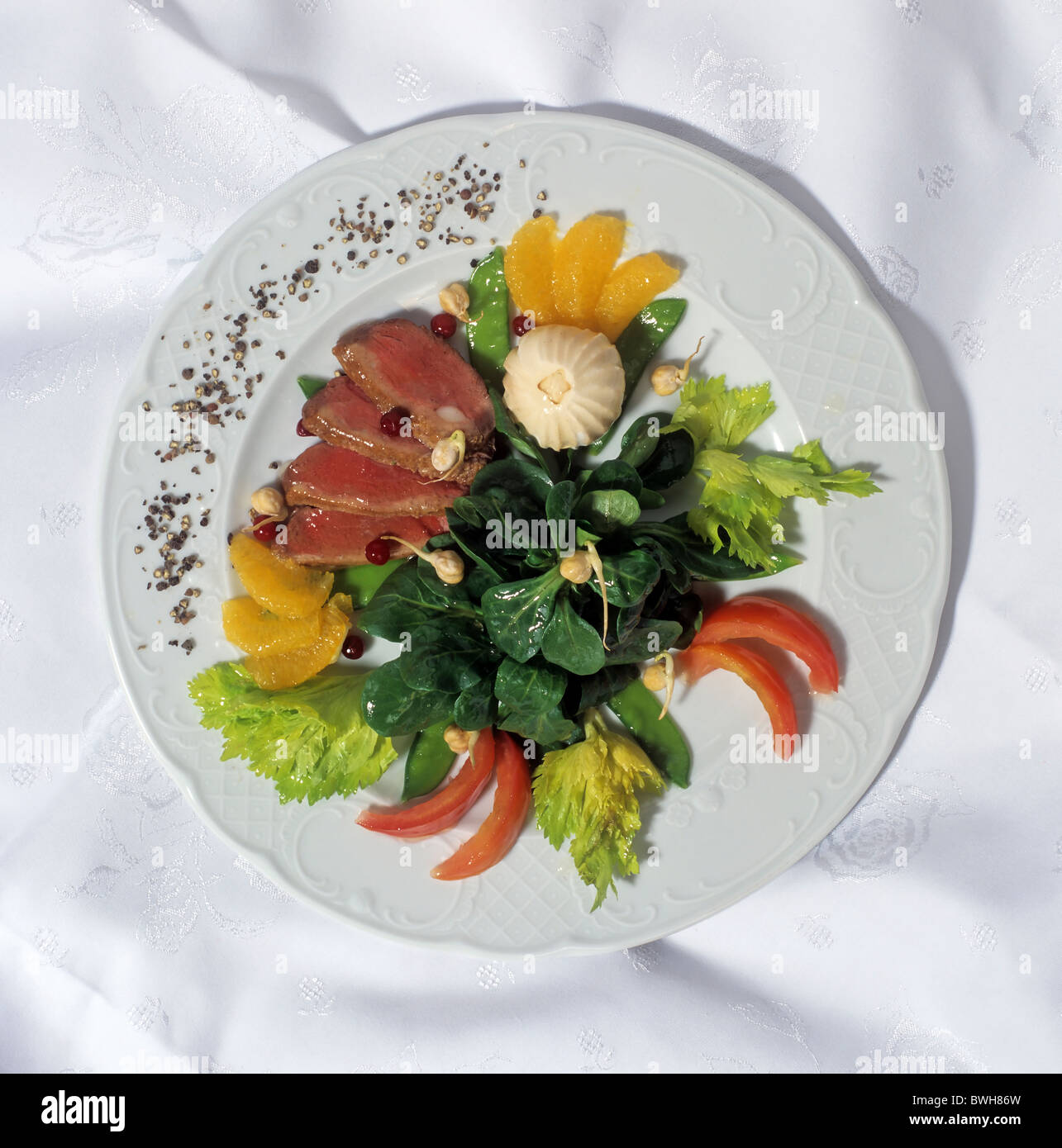 Kalorienarme Gourmet-Gericht À la Haute Cuisine mit zarten Scheiben vom Rinderfilet auf Rucola-Salat Stockfoto