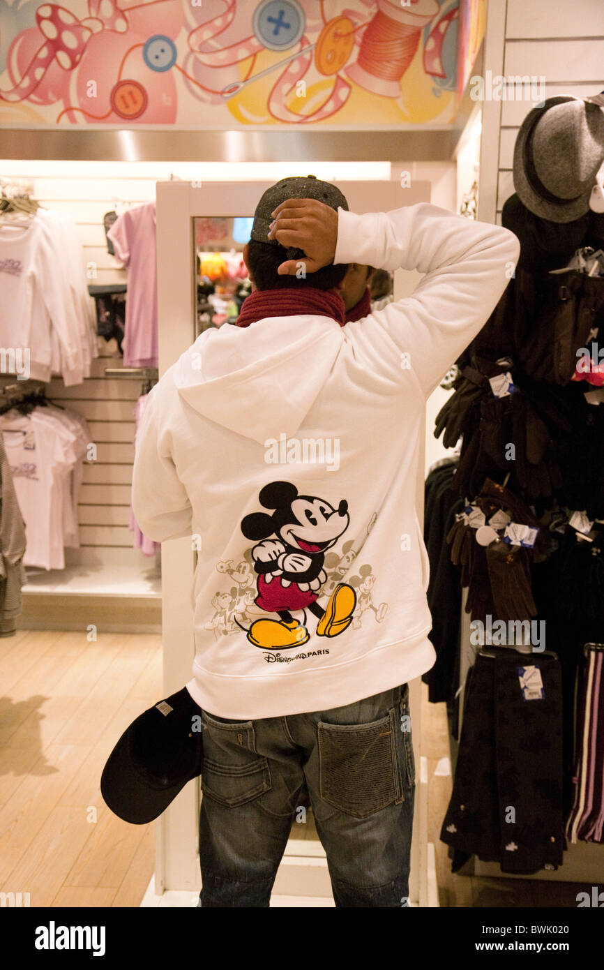 Ein Mann versucht auf Disney Kleidung im Disney Store, the Village  Disneyland Paris, Frankreich Stockfotografie - Alamy