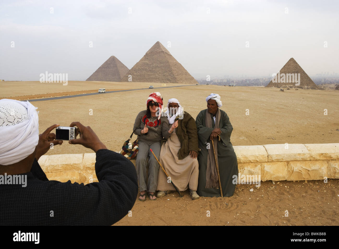 Touristen und einheimische Männer vor den Pyramiden von Gizeh, Kairo, Ägypten, Afrika Stockfoto