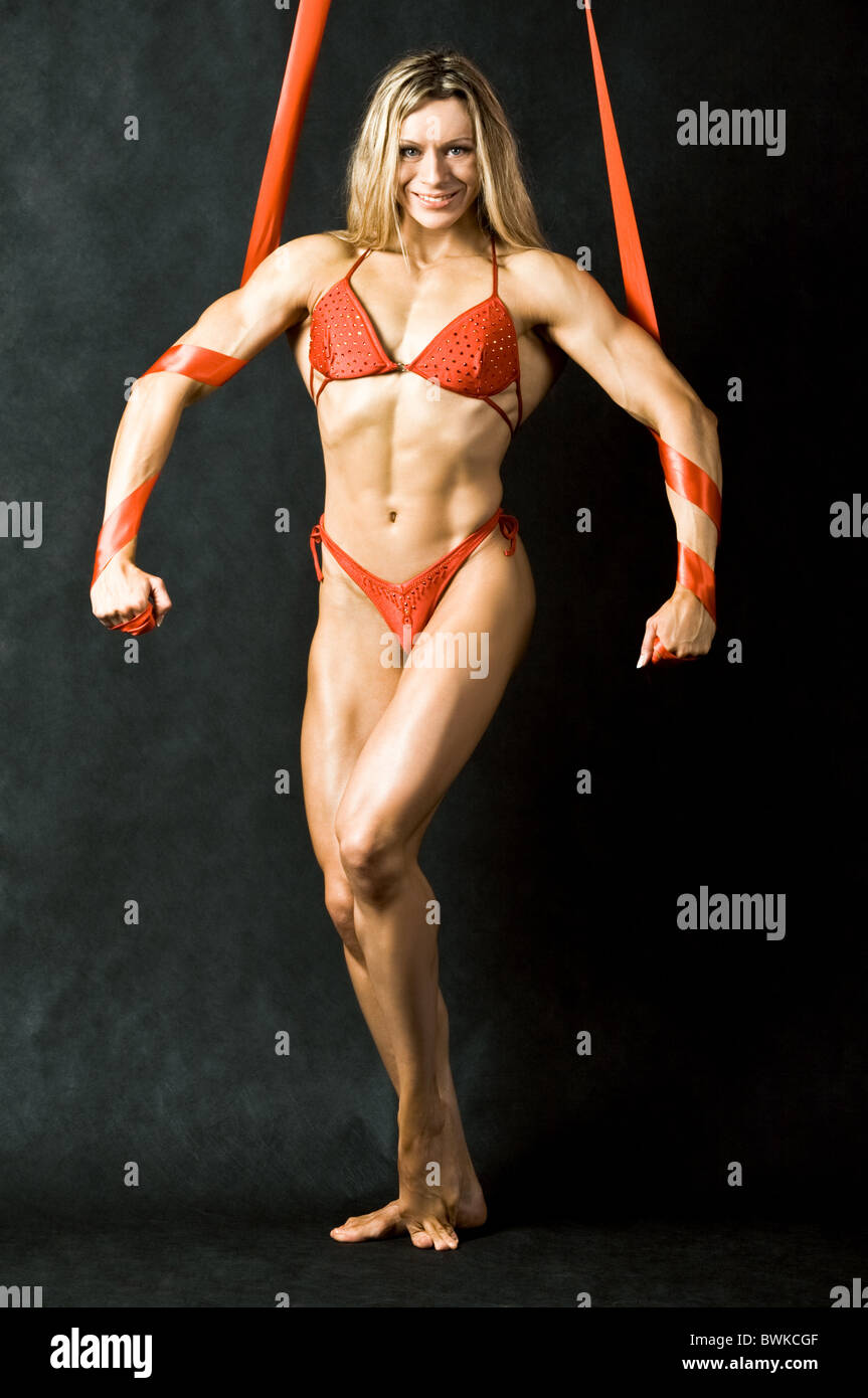 Porträt der starke Frau im roten Bikini Blick in die Kamera auf schwarzem Hintergrund Stockfoto