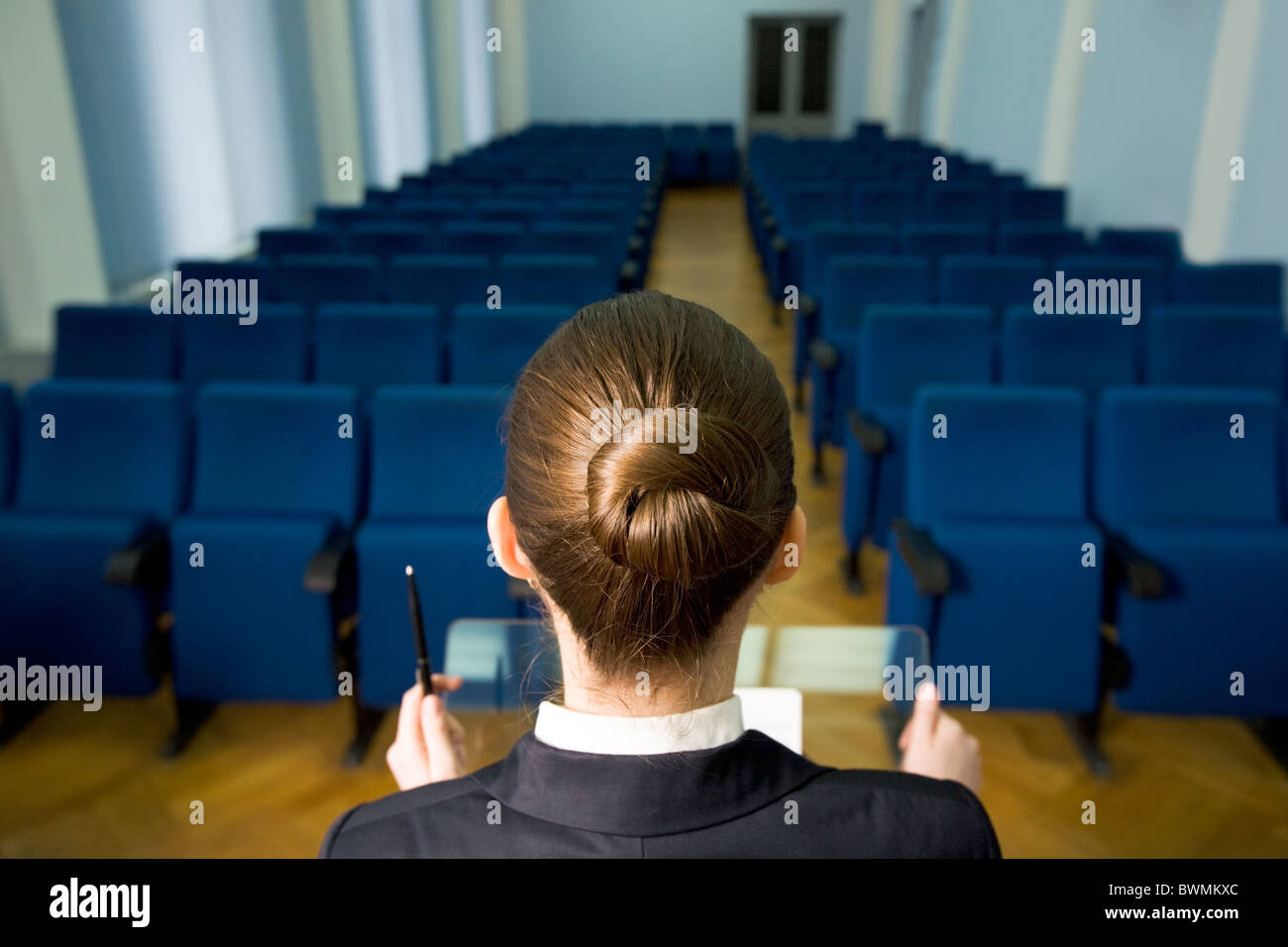 Rückansicht des Vortragenden Kopf vor Zeilen der Sessel im Konferenzsaal Stockfoto