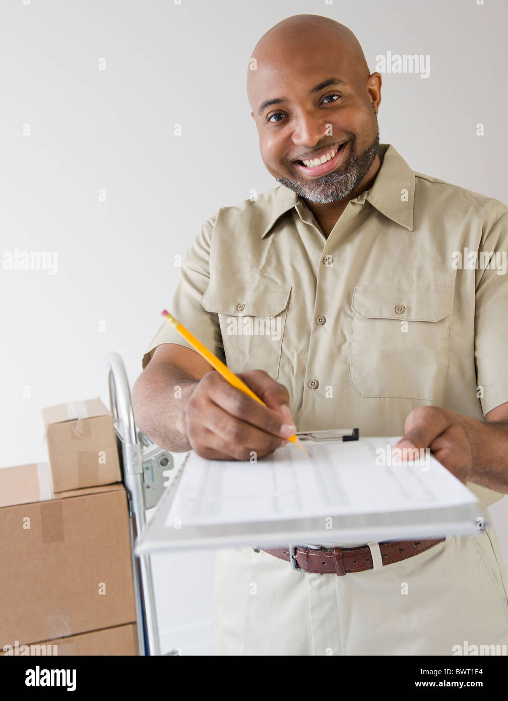 African American Auslieferers durchhalten Zwischenablage zur Unterzeichnung Stockfoto