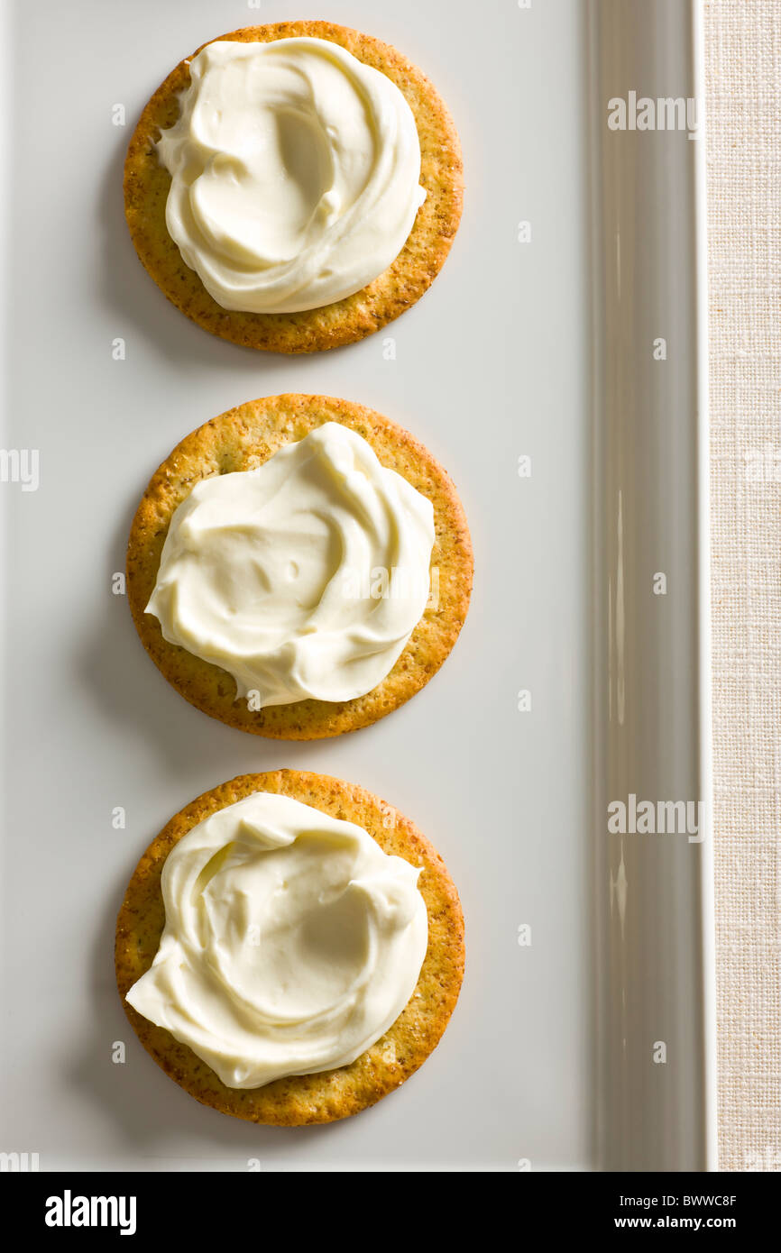 Kekse mit cremiger Käse verteilen auf oben auf einem weißen rechteckigen Teller. Stockfoto