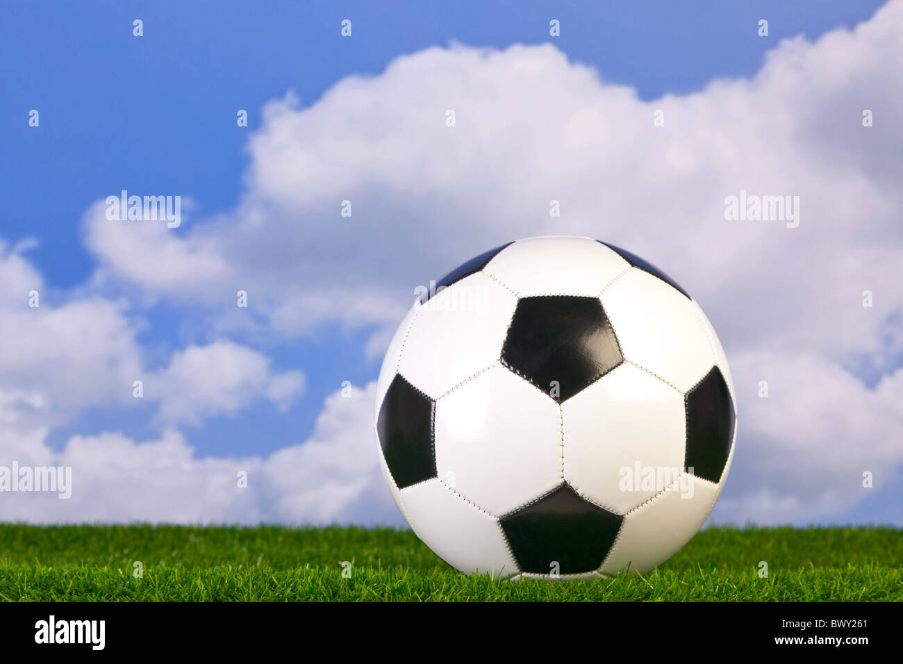 Foto von einem Fußball auf dem Rasen mit Himmelshintergrund. Stockfoto