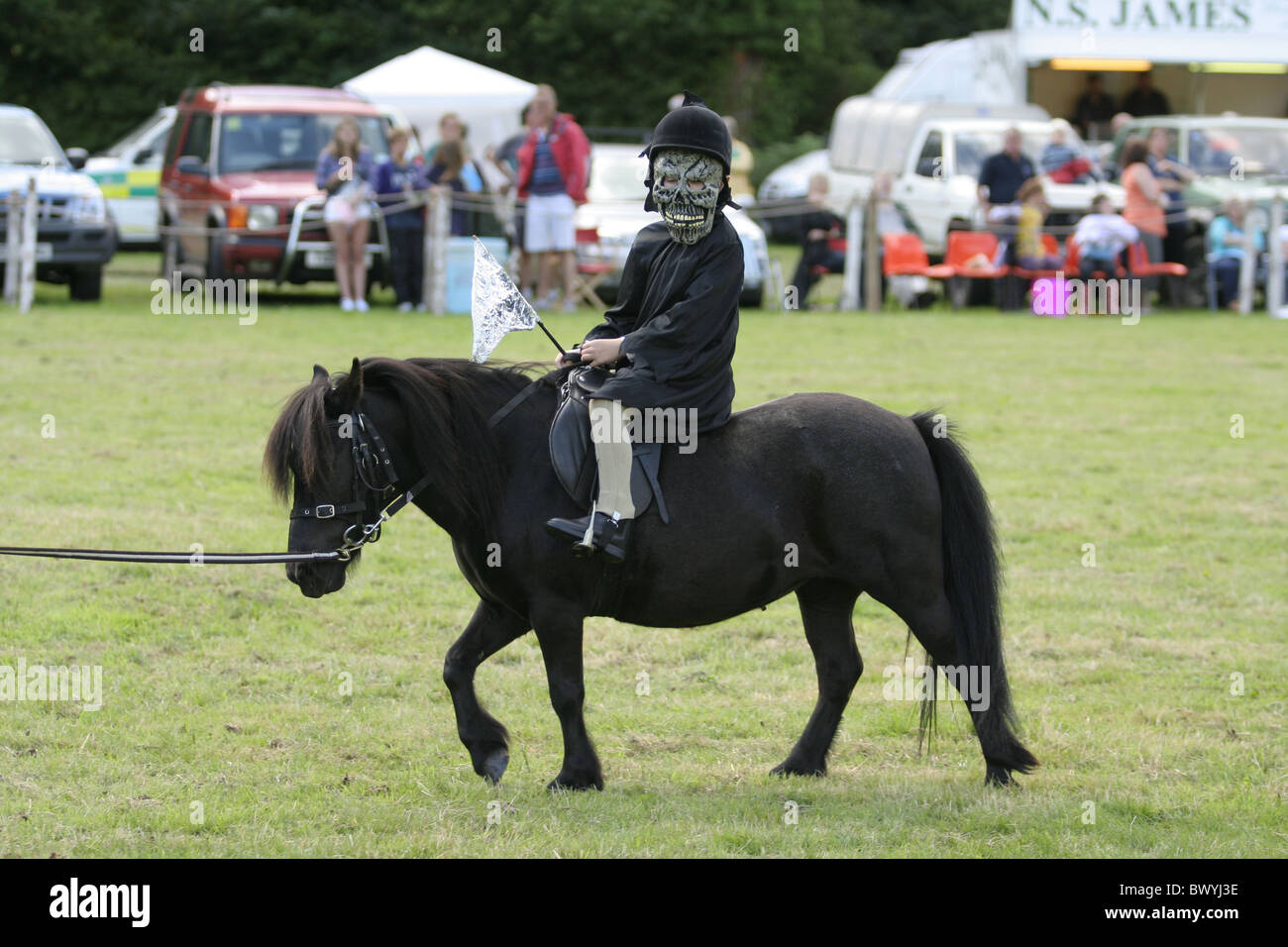 Fancy Dress Kind Reiter auf schwarzen Pony Show Stockfoto