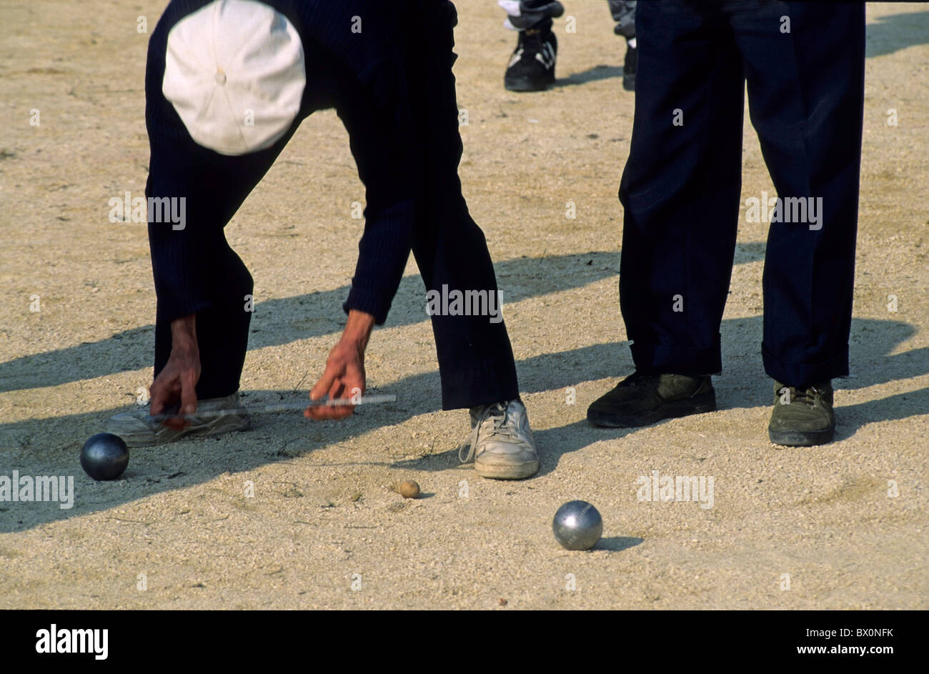 Boules-Wettbewerb - Mann, der die Distanz zwischen zwei Boules mit einem Lineal misst, um einen Gewinner zu ermitteln, Provence, Frankreich. Stockfoto