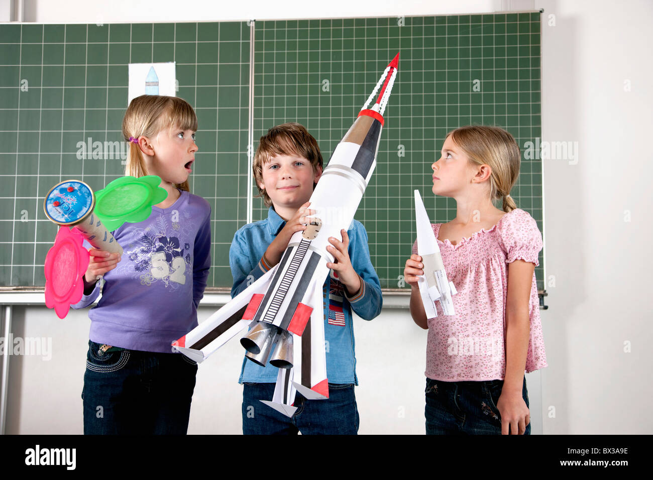 kleiner Junge im Klassenzimmer, Modell der Rakete Stockfoto