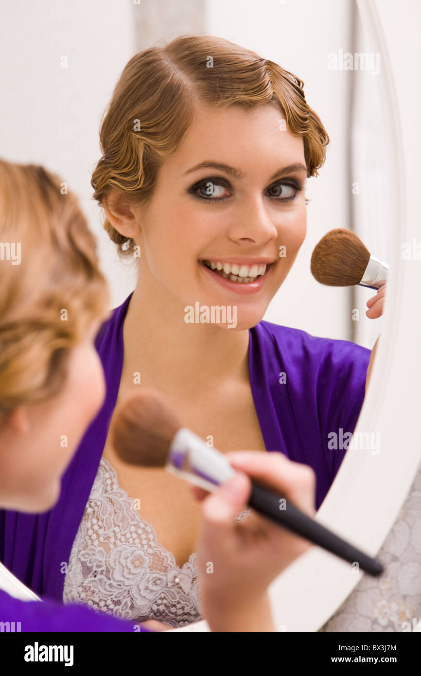 Bild der hübschen weiblichen Blick in Spiegel und Make-up zu tun Stockfoto