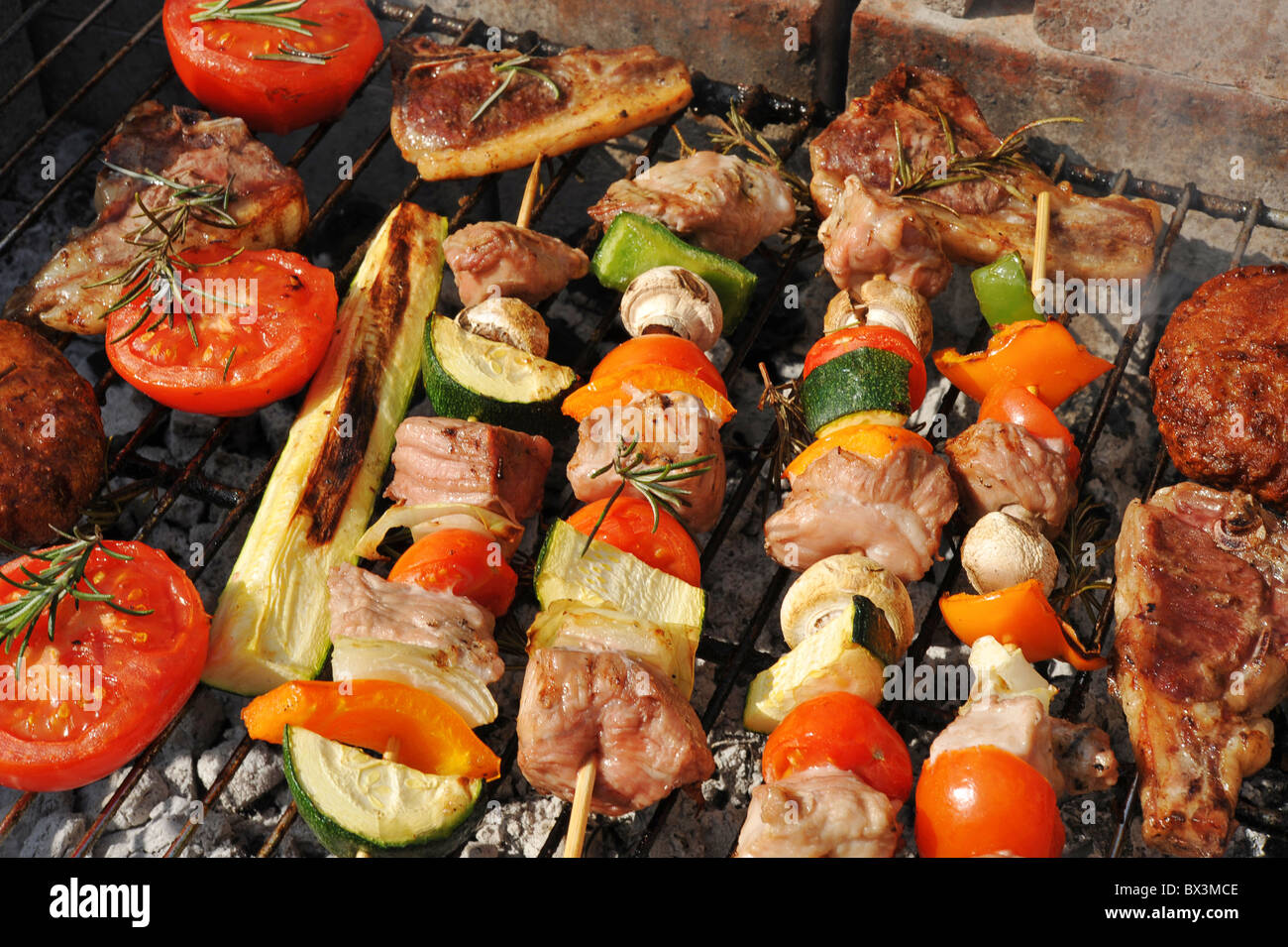 Fleisch und Gemüse kochen auf dem Grill im Freien. Fokus im Zentrum. Stockfoto