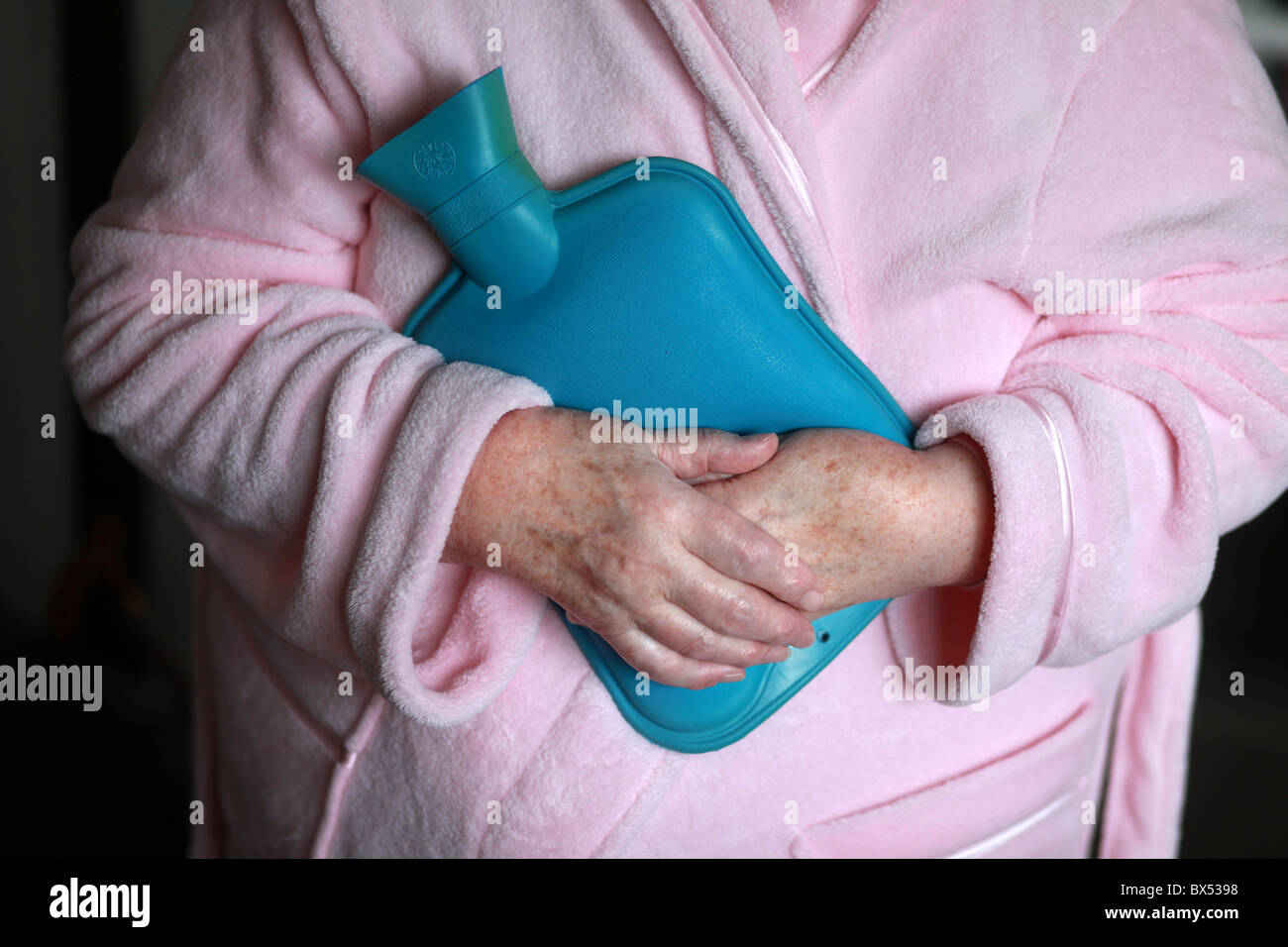Bild von Mark Passmore/markpassmore.com. 09.12.2010. Eine alte Dame hält im Winter warm mit Hilfe einer Wärmflasche. Stockfoto