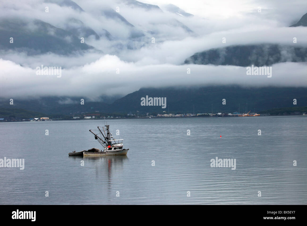 Ein Fischerboot trolling in der Bucht auf der Kenai Penninsula Valdez, Alaska USA mit Bergen und Nebel im Hintergrund. Stockfoto