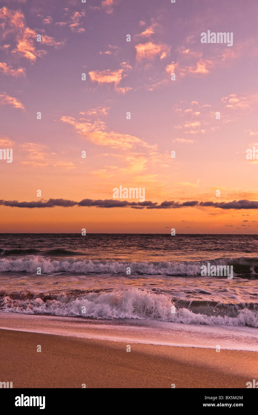 Meeresbrandung unter goldenen Sonnenuntergang Wolken. Florida, USA Stockfoto