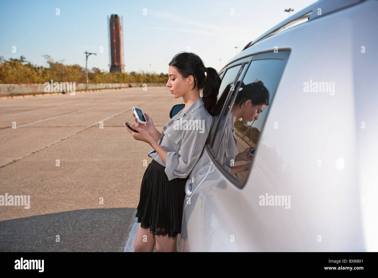 Mädchen auf Handy und PDA mit dem Auto Stockfoto