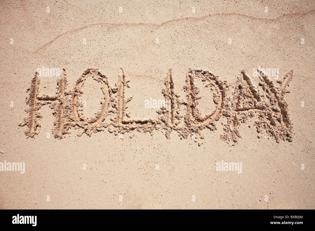 Urlaub auf Sand geschrieben Text Stockfoto