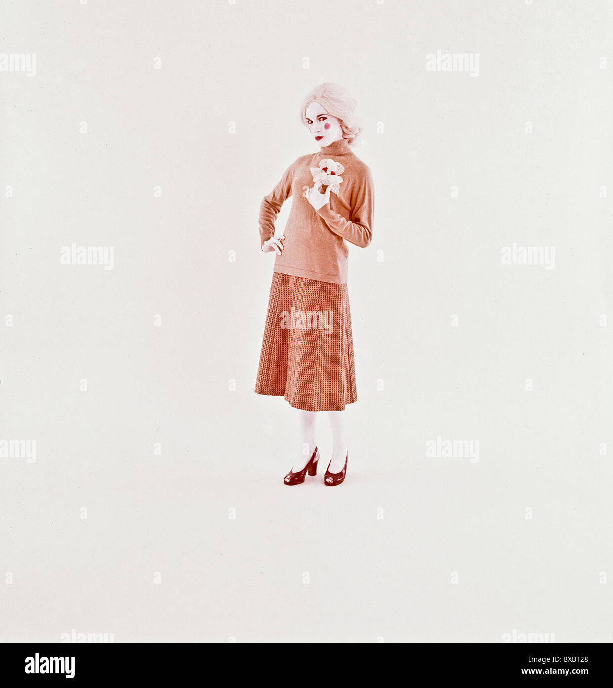 Weißes Gesicht gegenüber weiblichen Mime in alten altmodischen Stil Kleid. Stockfoto