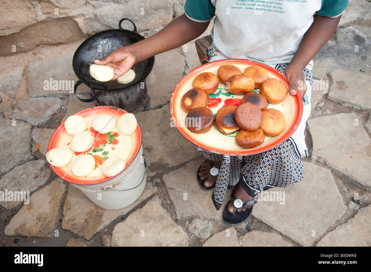 Eine junge Frau kocht Mandazi (Krapfen) auf den Straßen von Dodoma, Tansania, Ostafrika. Stockfoto