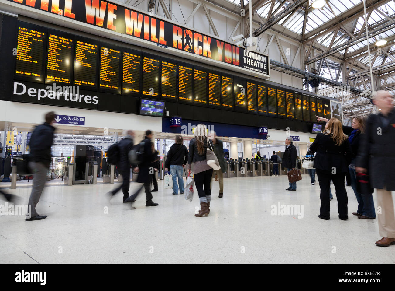 Pendler und Reisende auf das Zusammentreffen der Waterloo Station zeigt den Zeitplan über ihnen. Stockfoto