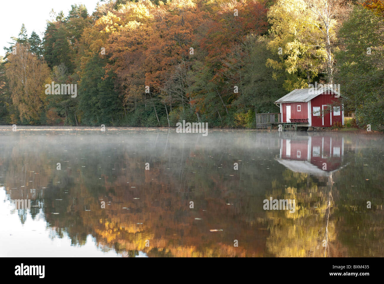 Seehauses Sjöbod von See Sävelången im Herbst 2010. schwedischen roten Landhaus mit weißen Streifen. Spiegelung im Wasser Stockfoto