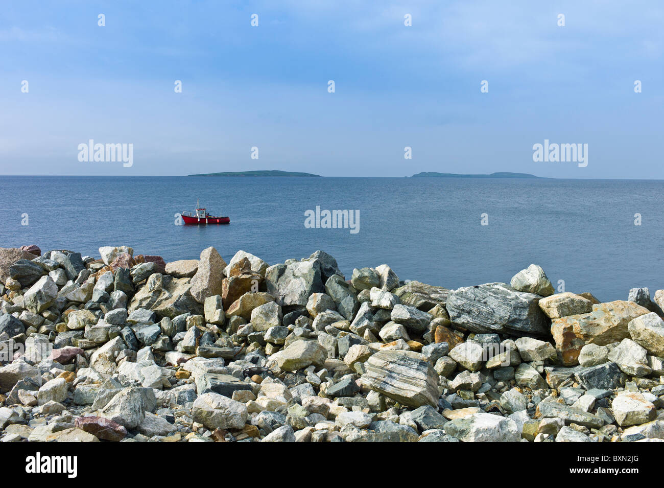 Angelboot/Fischerboot mit Saltee Inseln im Hintergrund und Meer Abwehrkräfte, Kilmore, County Wexford, Irland Stockfoto