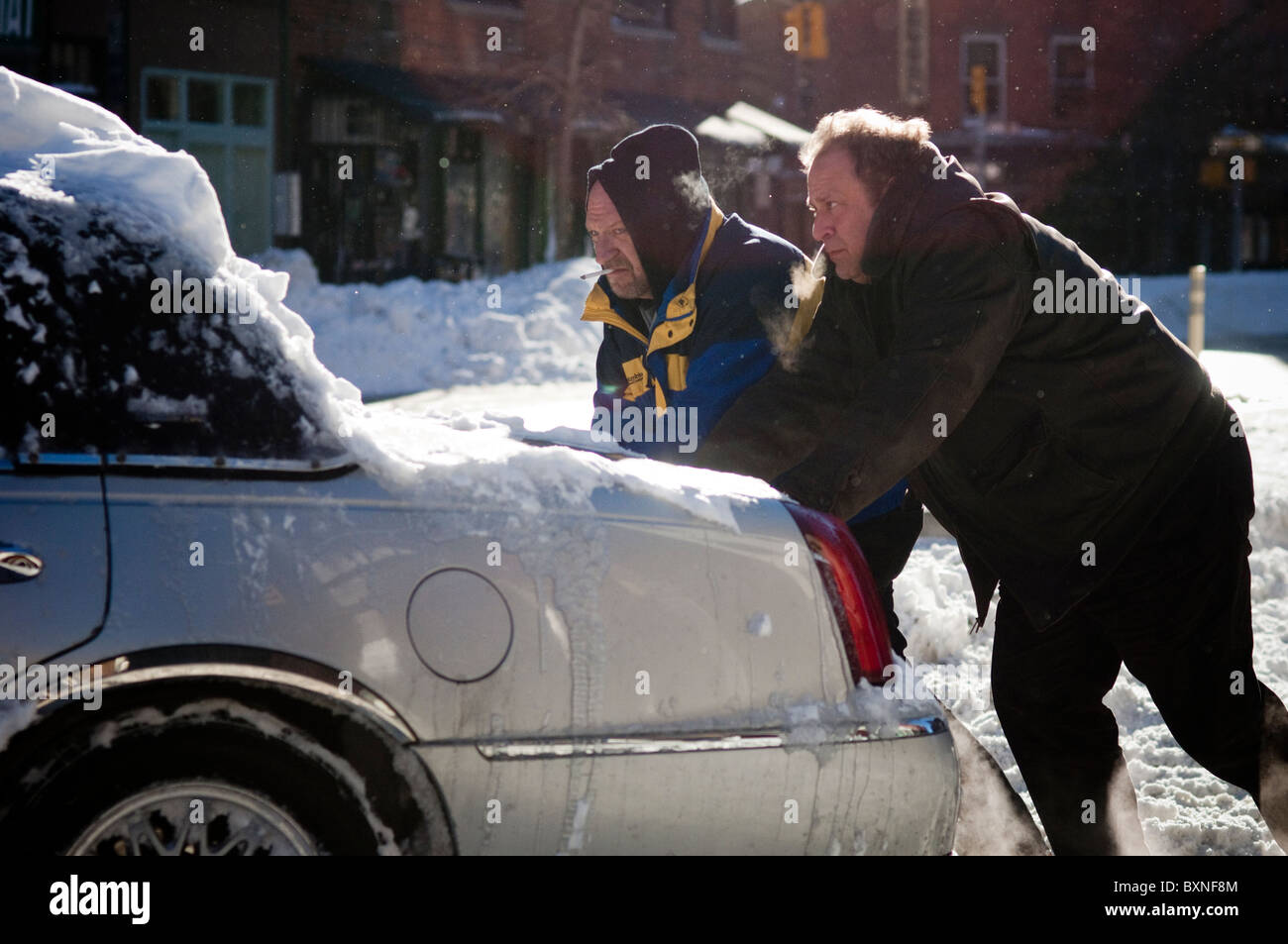 Zwei Männer ein Auto stecken im Schnee im Stadtteil Greenwich Village in New York Stockfoto
