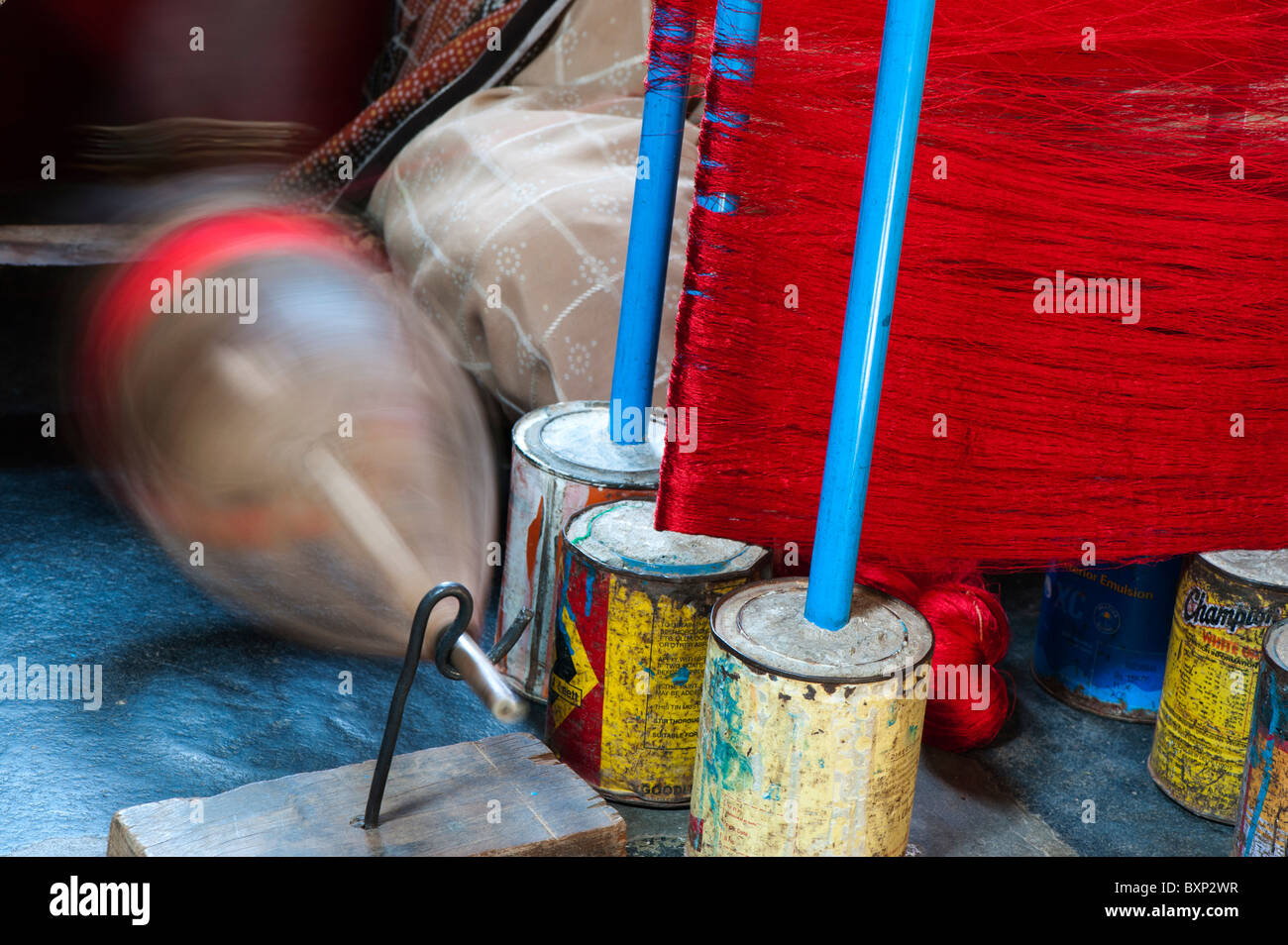 Indische Frau einen Sari Handwebstuhl mit farbigen Seidenfäden an Spindeln arbeiten. Andhra Pradesh, Indien Stockfoto