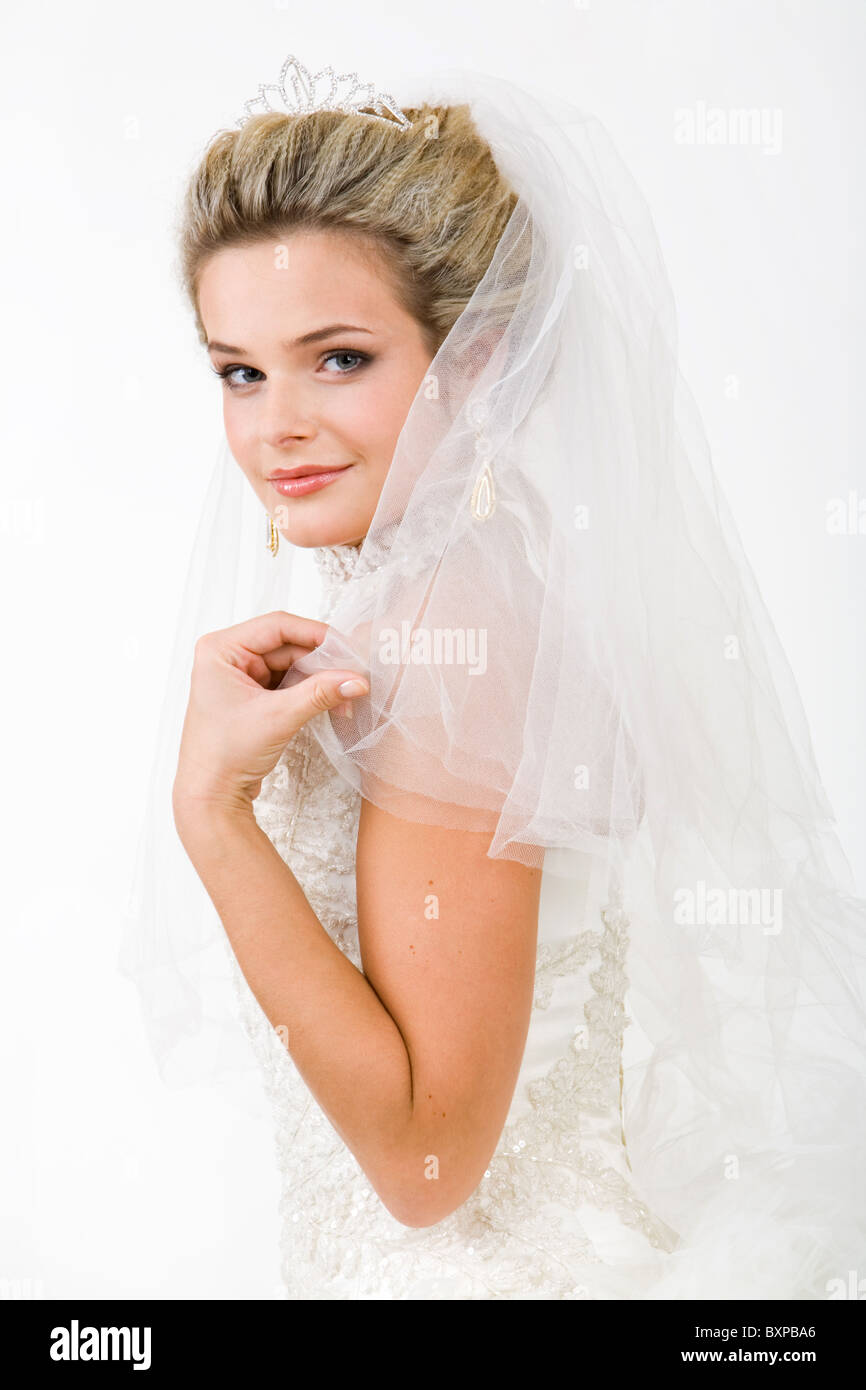 Porträt der hübsche Braut Schleier tragen und beim Blick in die Kamera zu berühren Stockfoto