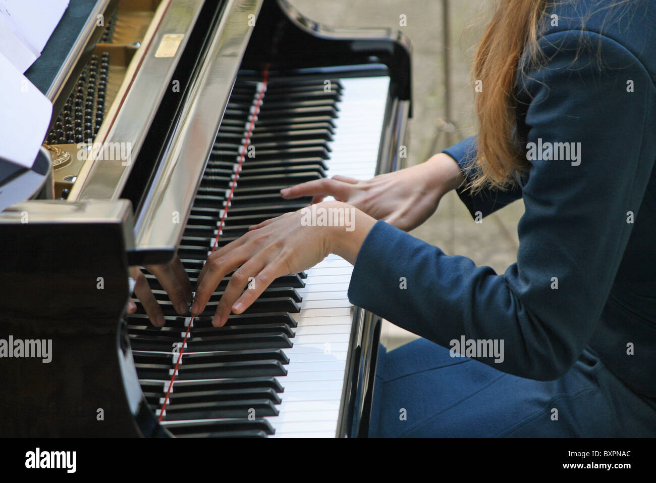 weibliche Pianisten während der sanfte Klang von einer Klaviertastatur Stockfoto