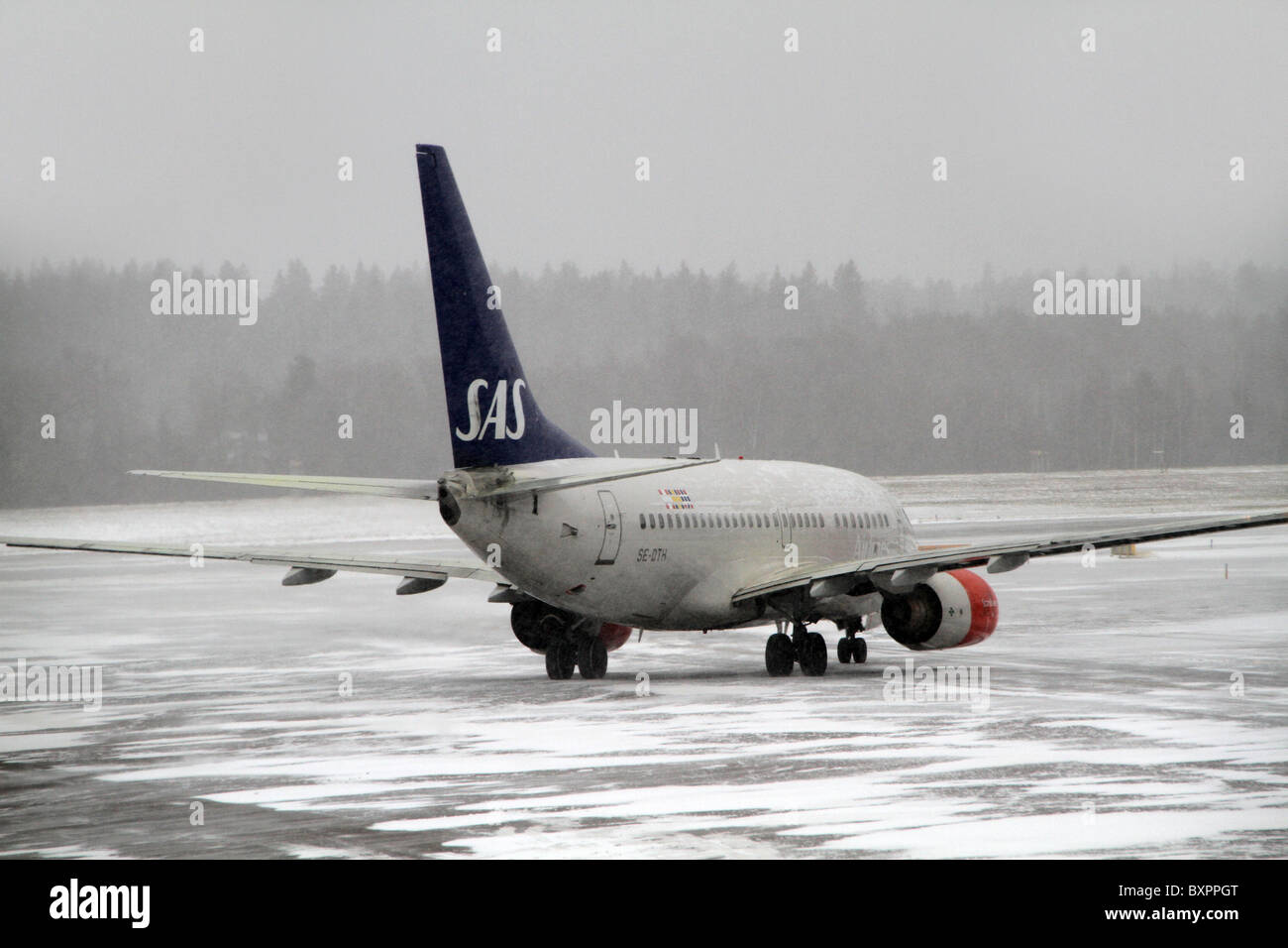 Flughafen Arlanda, Stockholm, Schweden. SAS-Flugzeugen auf dem Rollfeld in einem Schnee gebunden und nebligen Tag am Flughafen Arlanda. Stockfoto