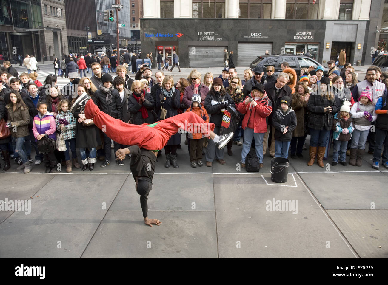Breakdancer unterhalten die Massen vor der New York Public Library in der 5th Avenue in der Vorweihnachtszeit in New York City. Stockfoto