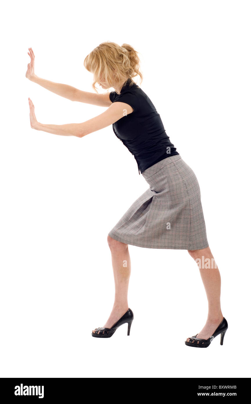 Business-Frau treibt ein imaginäres Objekt auf einem weißen Hintergrund isoliert Stockfoto