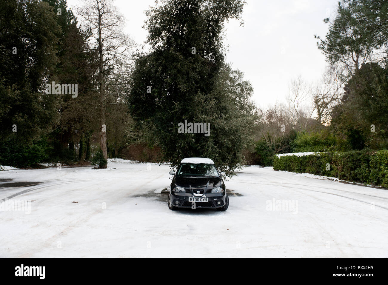 ein einziges Auto parkte auf einem Parkplatz an einem verschneiten Tag, UK Stockfoto