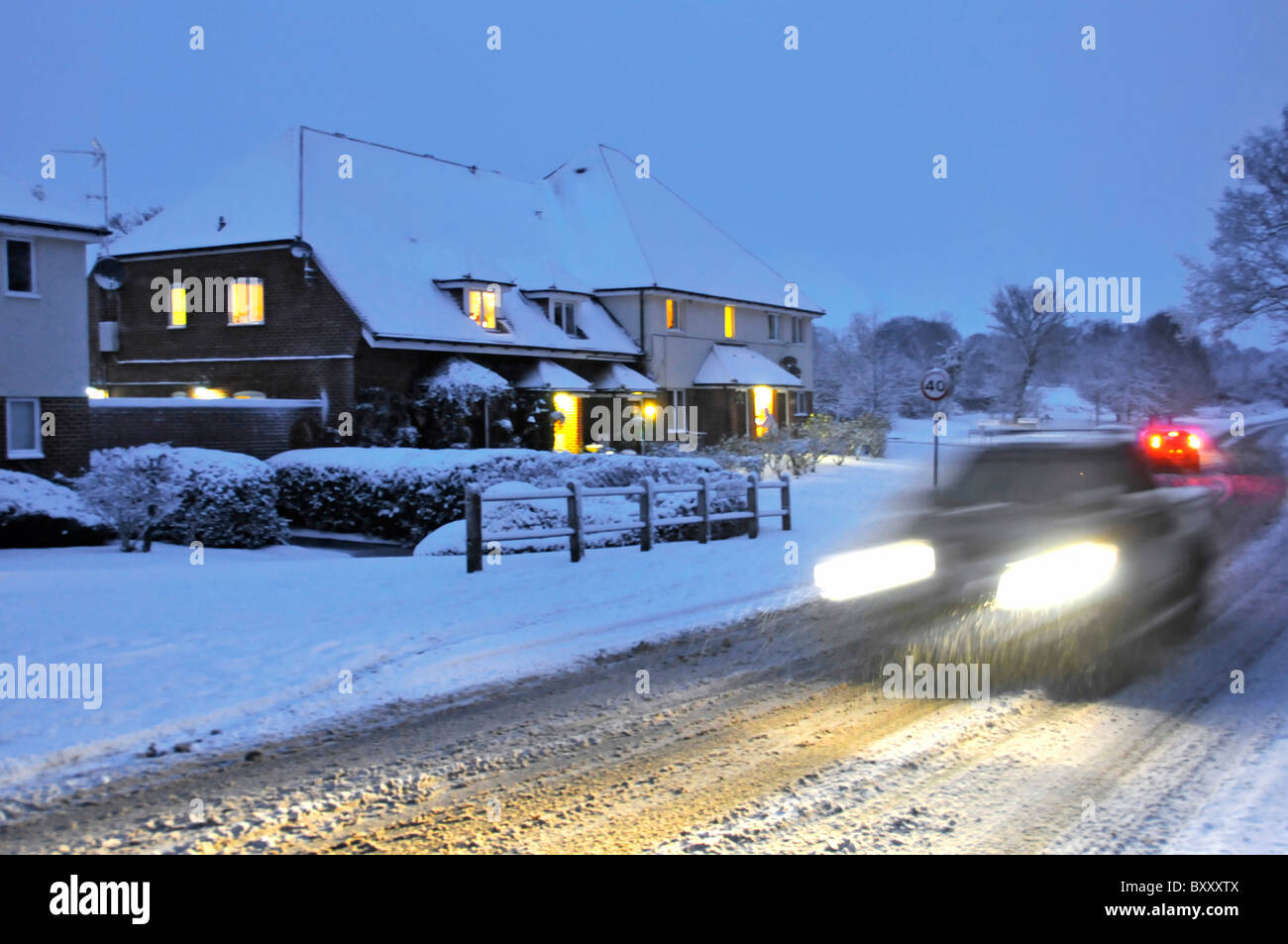 Fahren auf Schnee bedeckt Straßen in der Abenddämmerung Stockfoto