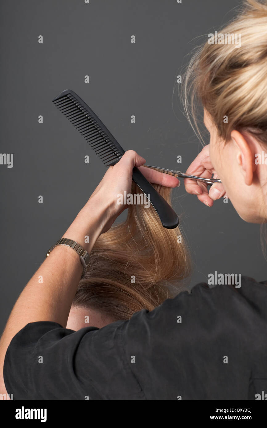 Ein Friseur, ein Client Haare schneiden Stockfoto