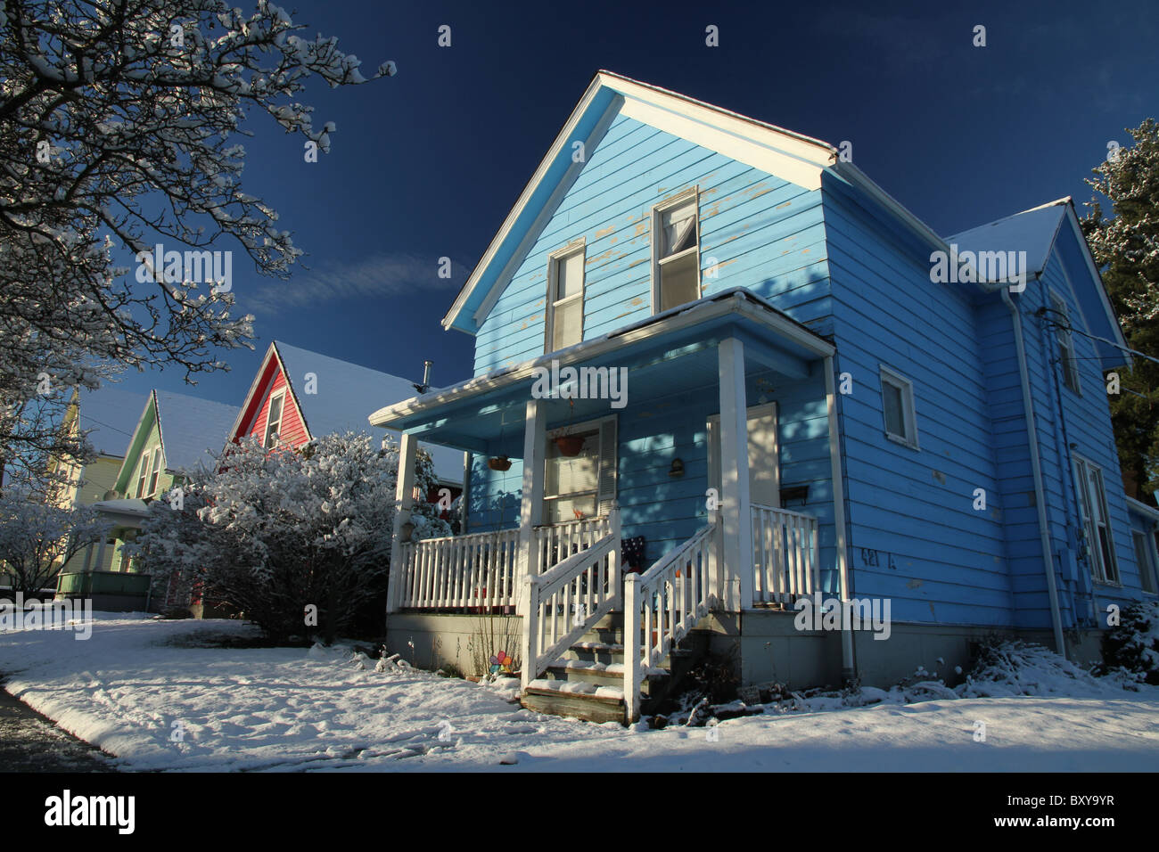 Vier Häuser; gelb, grün, rot und blau in den Schnee in Bellingham, WA, USA. Stockfoto
